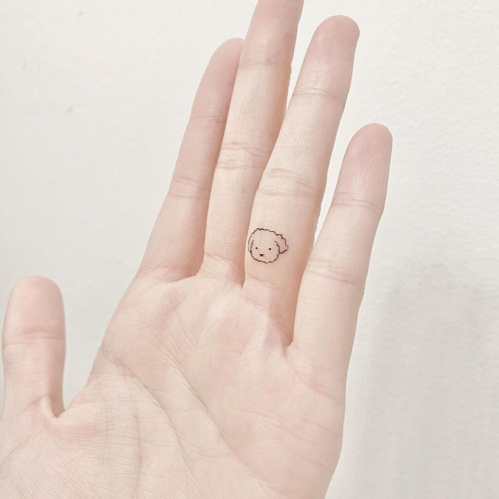 Dog finger tattoo