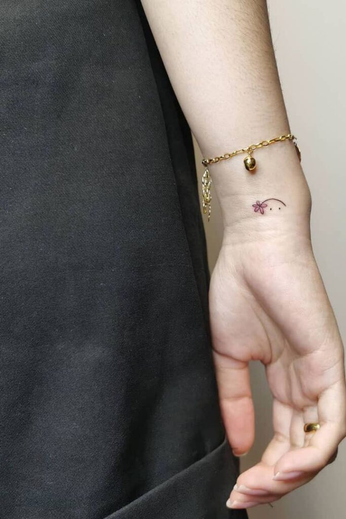 Smiling Flower Wrist Tattoo