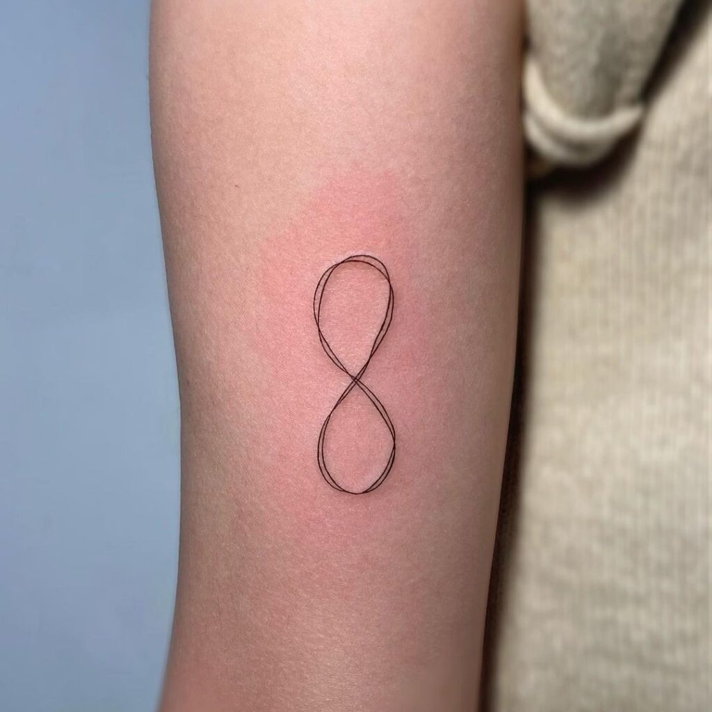 Creative infinity symbol line tattoo