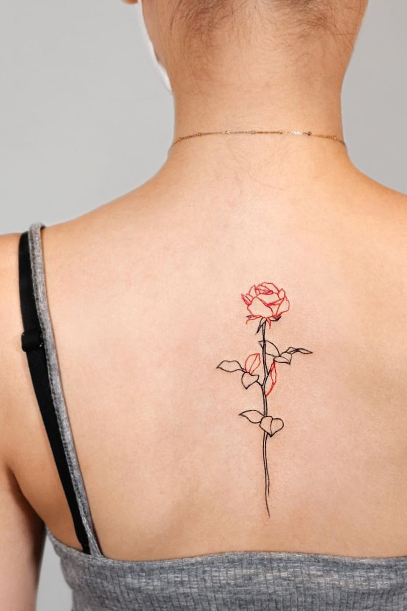 Red and black rose back tattoo