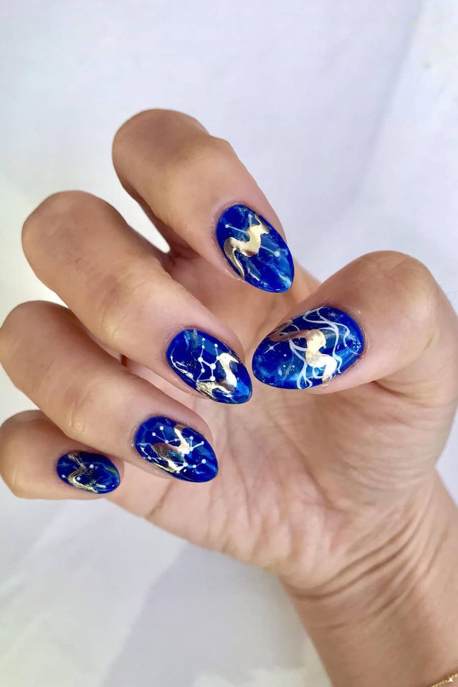 Bright blue constellation galaxy nails