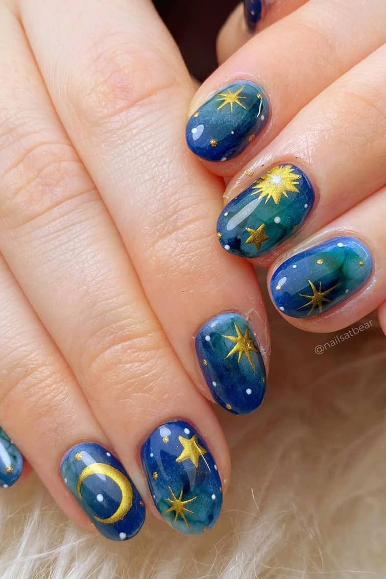 Golden and blue green galaxy nails