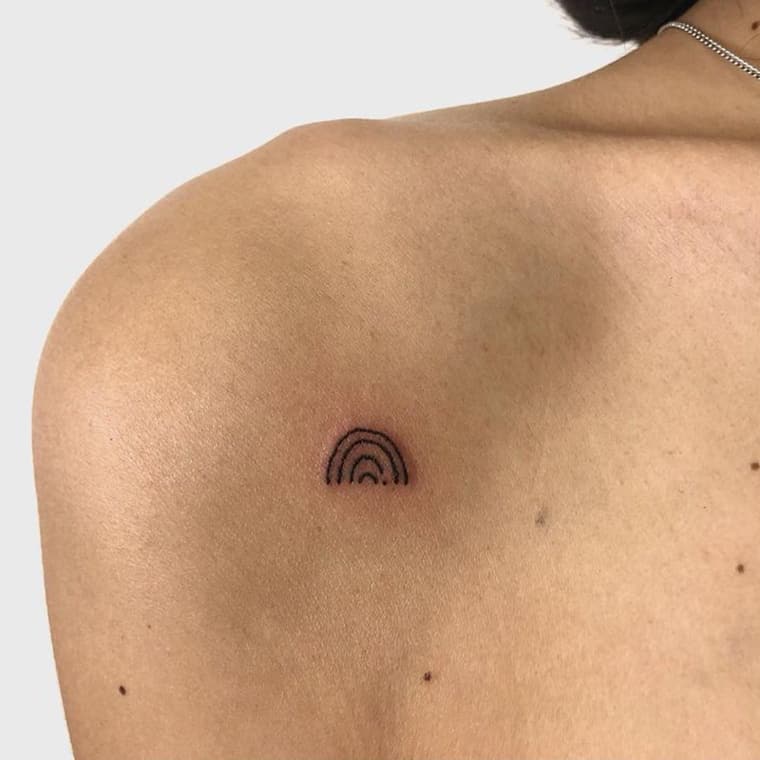 Minimalist rainbow tiny tattoo