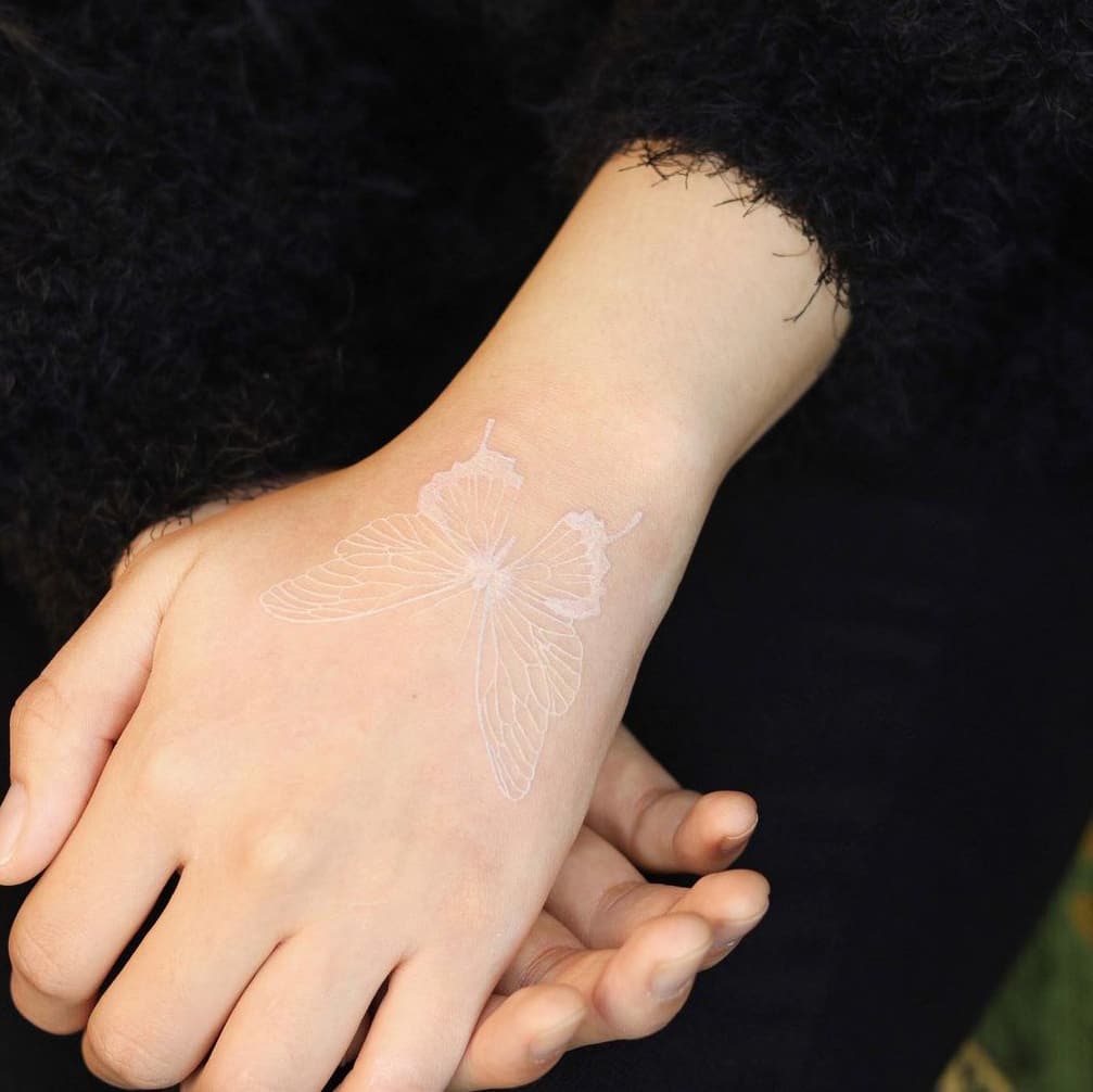White butterfly tattoo