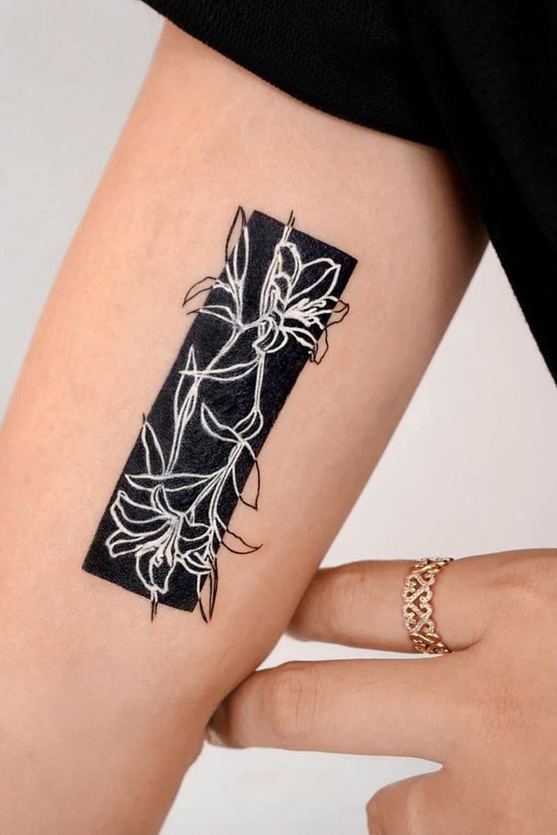 White floral tattoo with black background