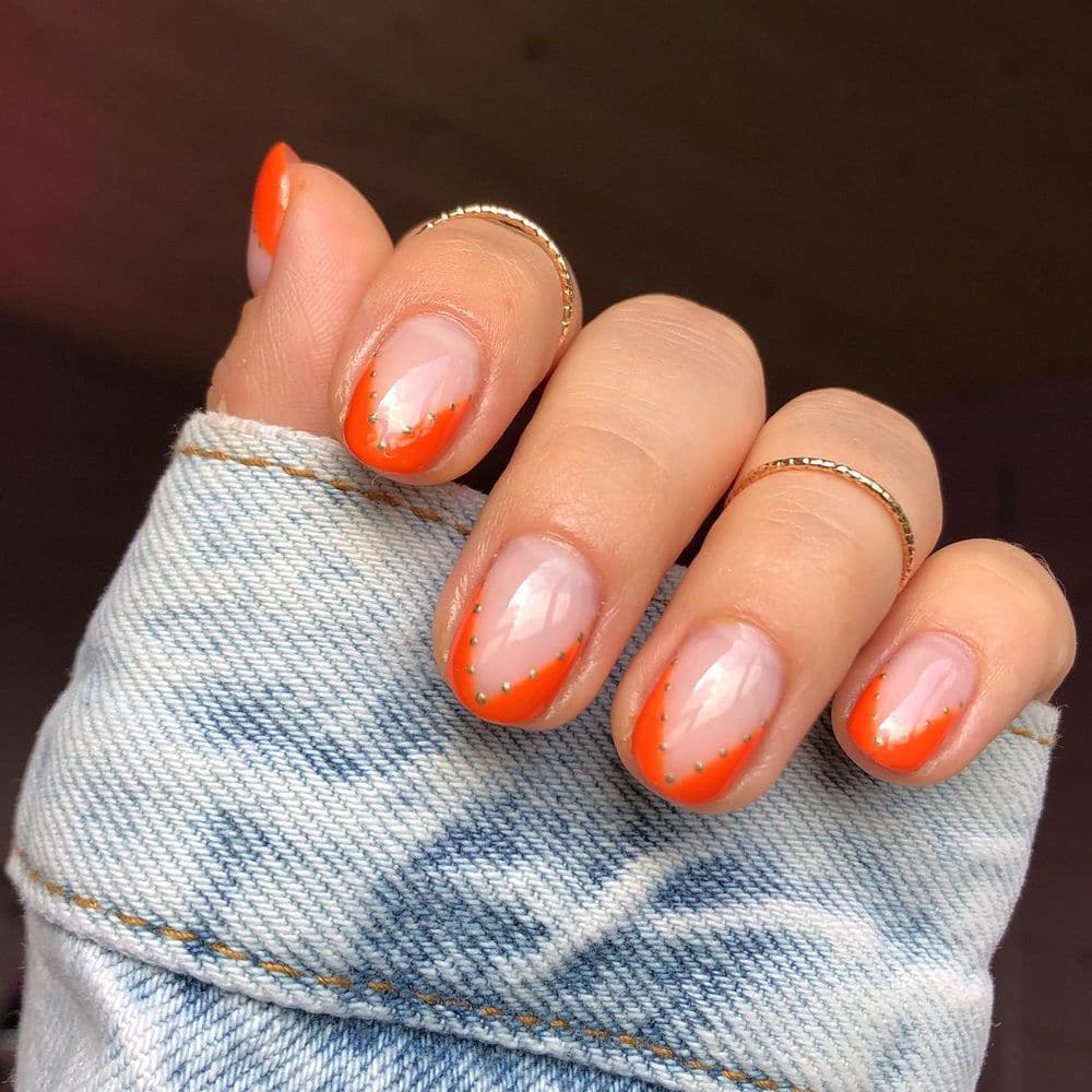 Delicate short orange nails