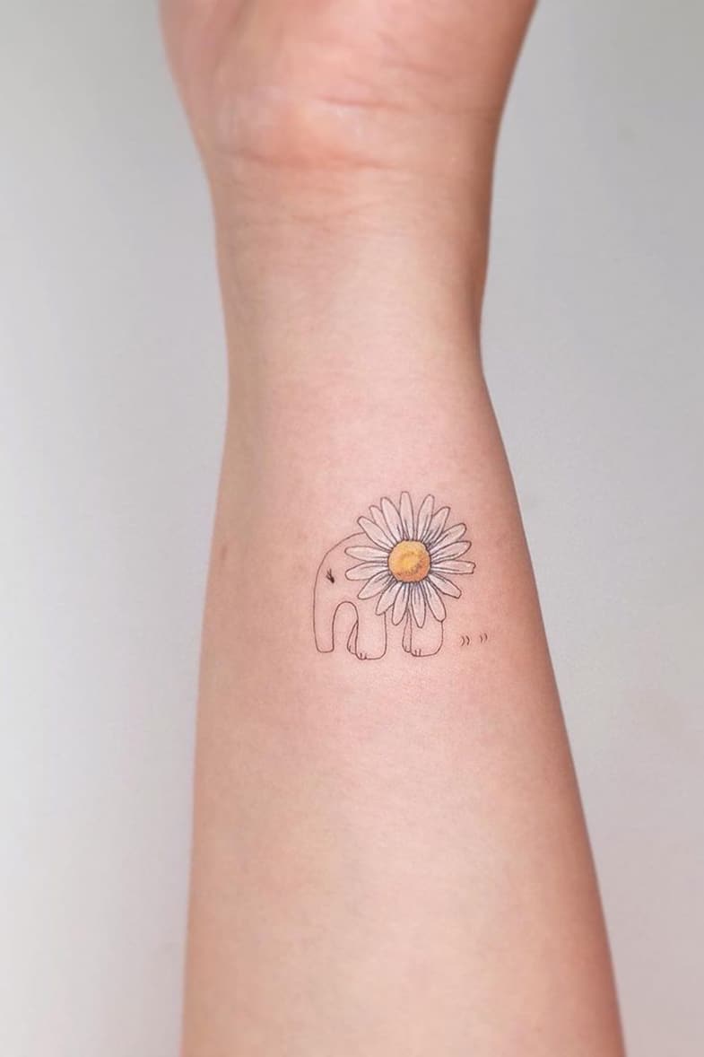 Elephant tattoo with daisies