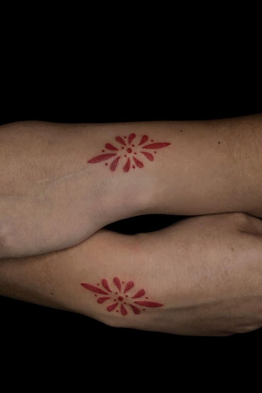 Red tattoo on hand