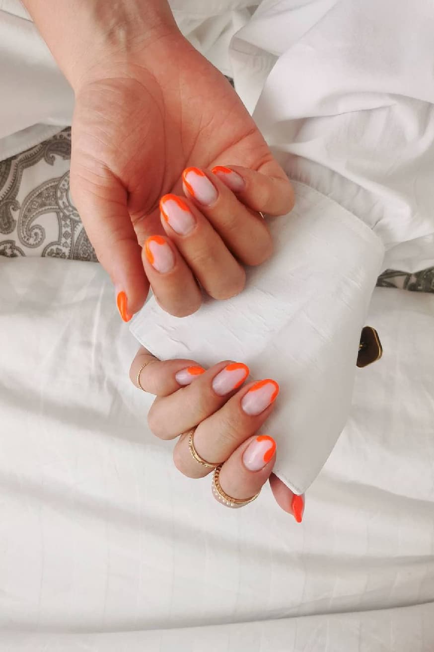 Soft orange French nails