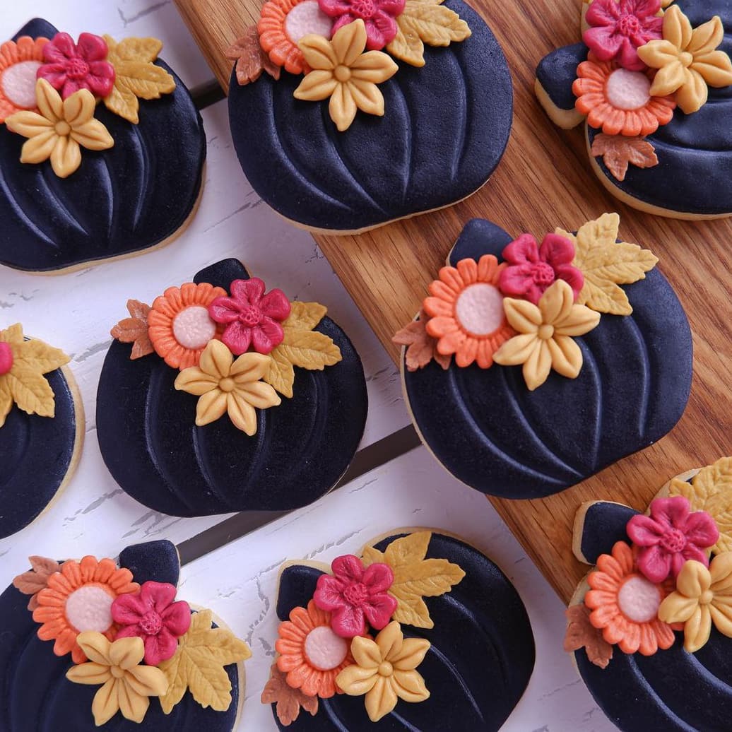 Black pumpkin cookies with flowers