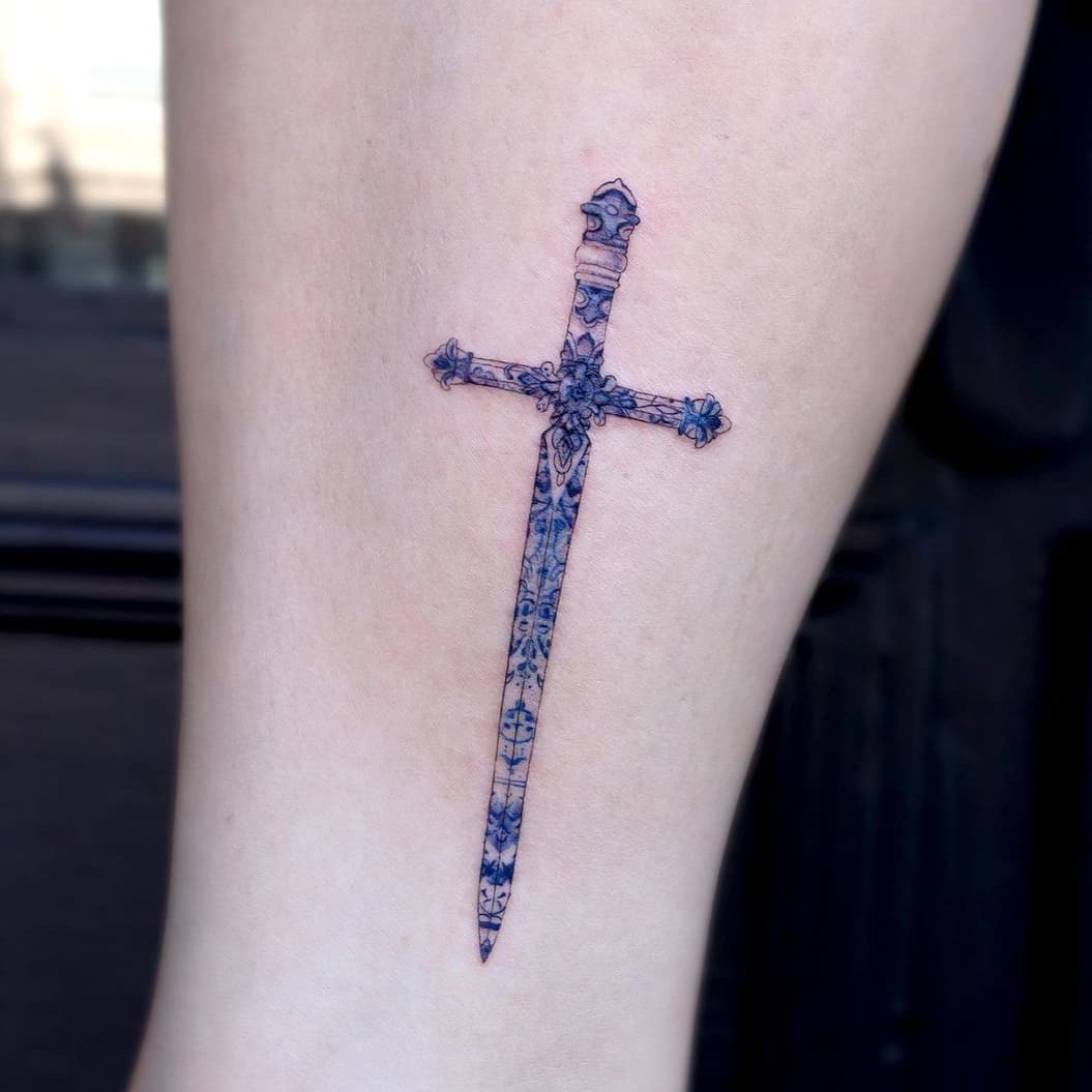 Blue printed sword tattoo