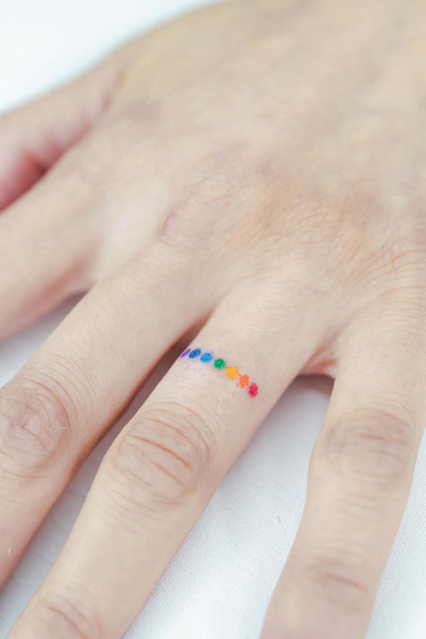 Rainbow dot tattoo on finger