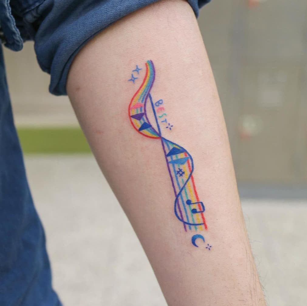 Rainbow music score tattoo