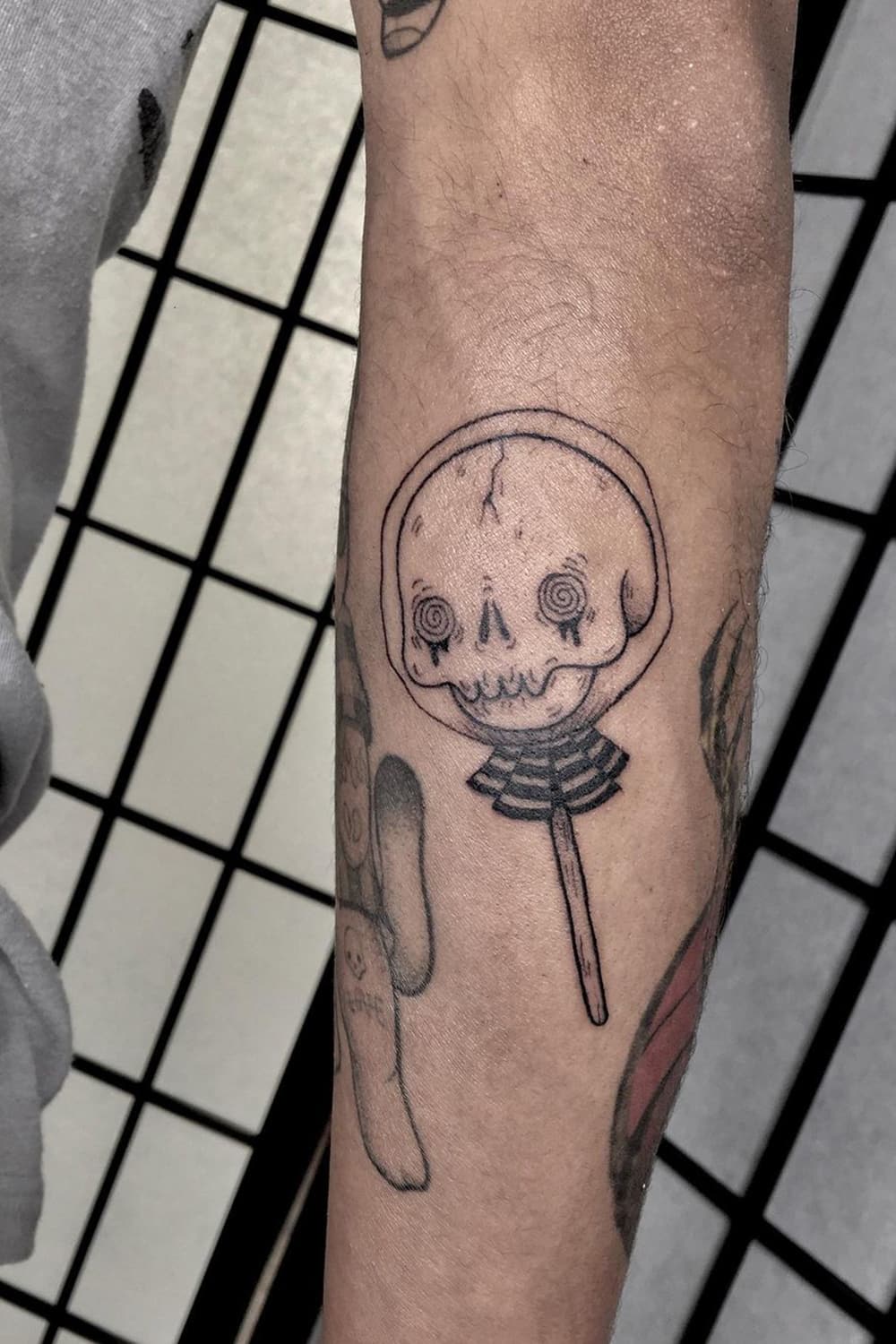 Skull lollipop tattoo