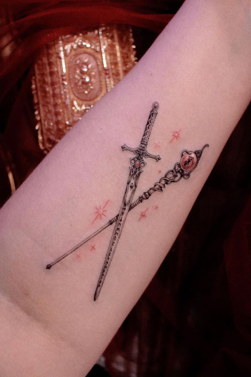 Staff and sword tattoo