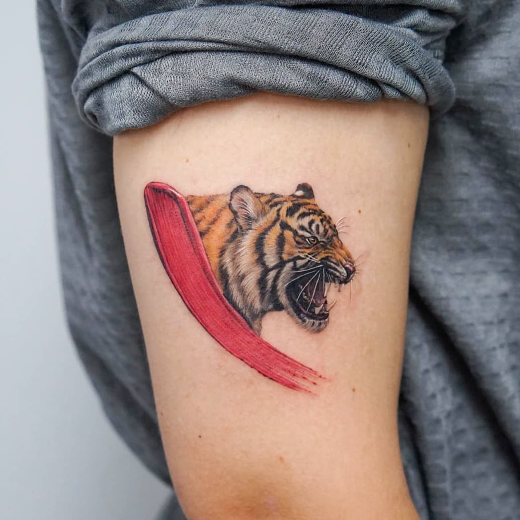 Red brushstroke tiger tattoo