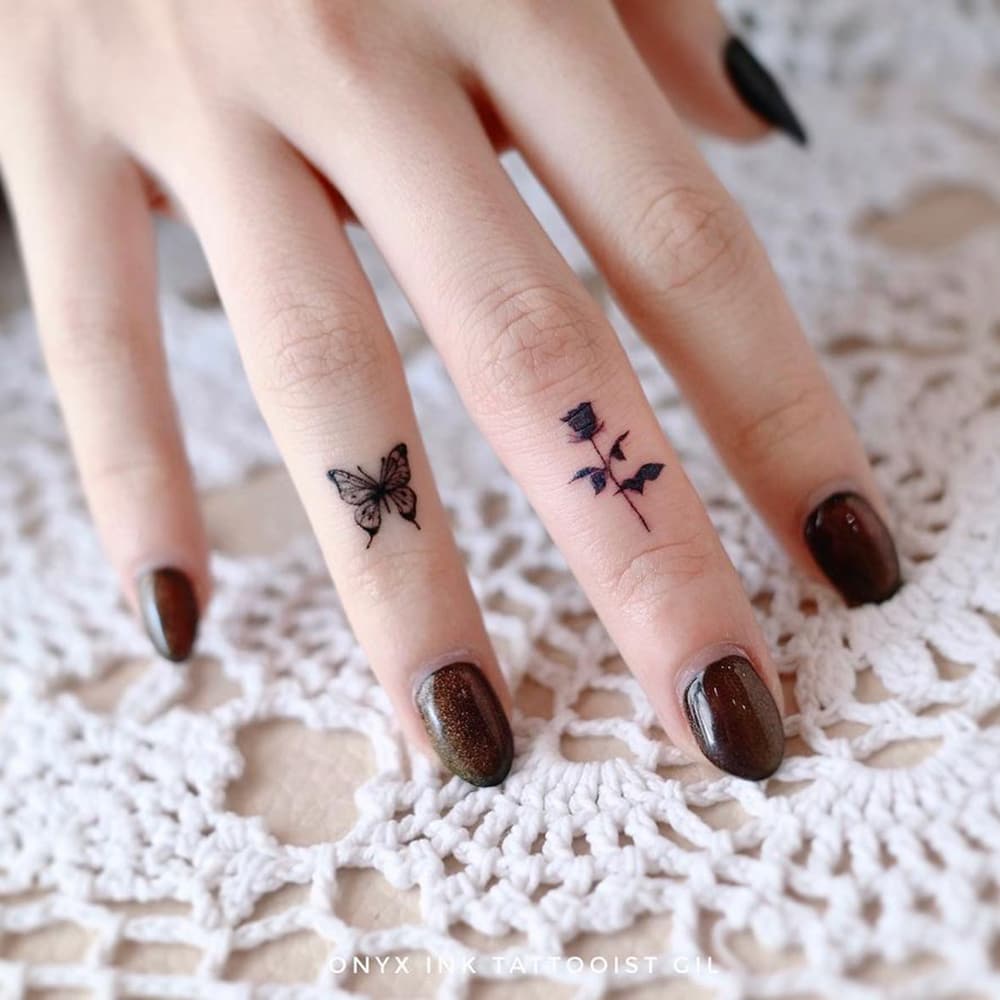 Black butterfly and rose ring tattoo