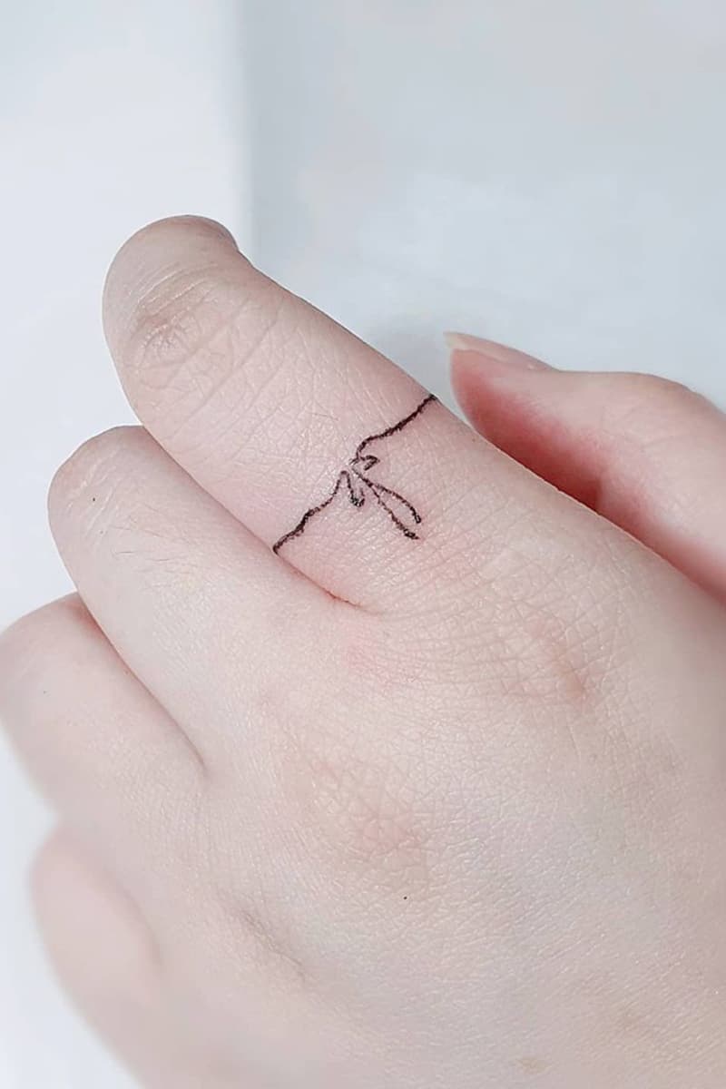 Bow ring tattoo