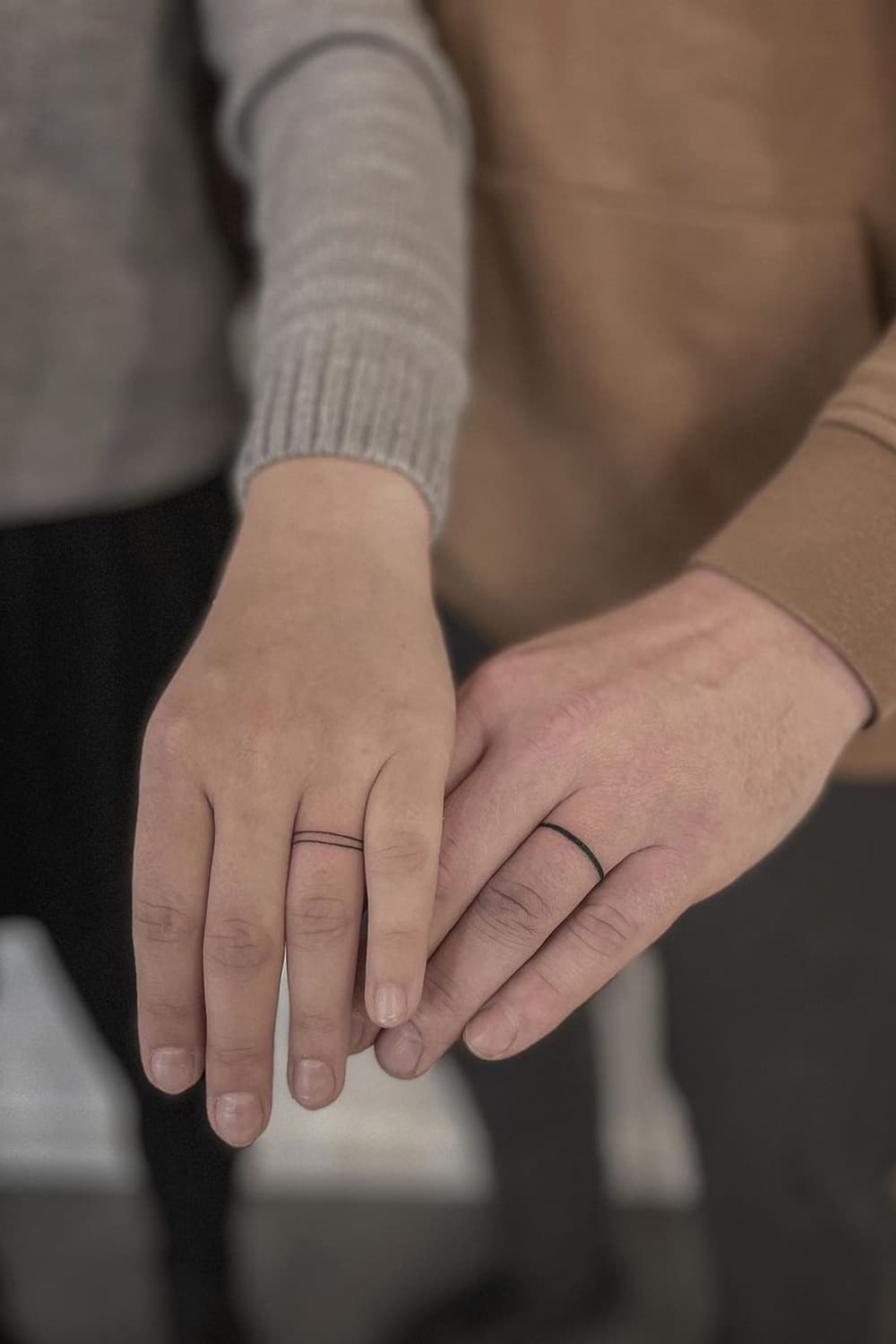 Minimalist couple ring tattoo