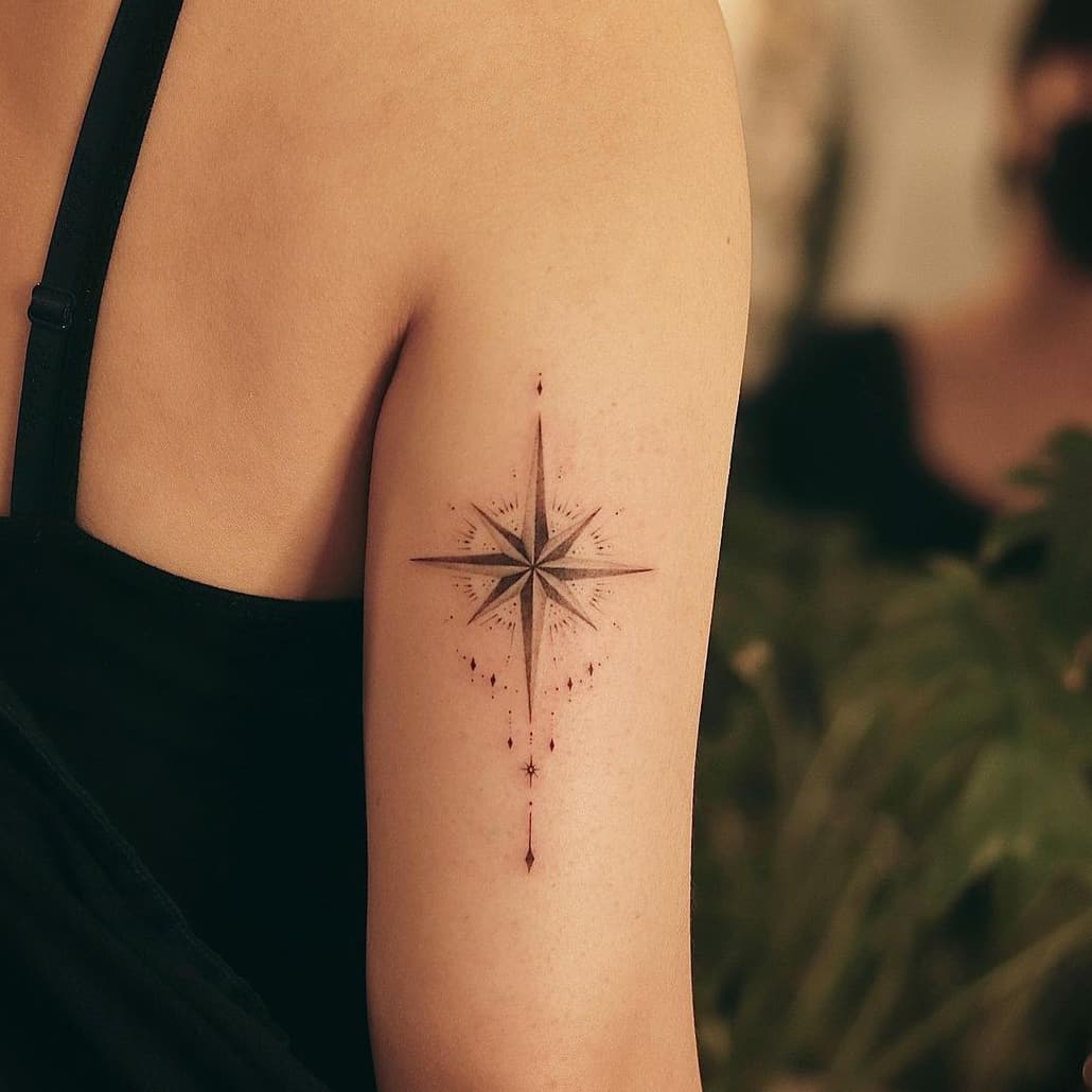 Shining compass tattoo
