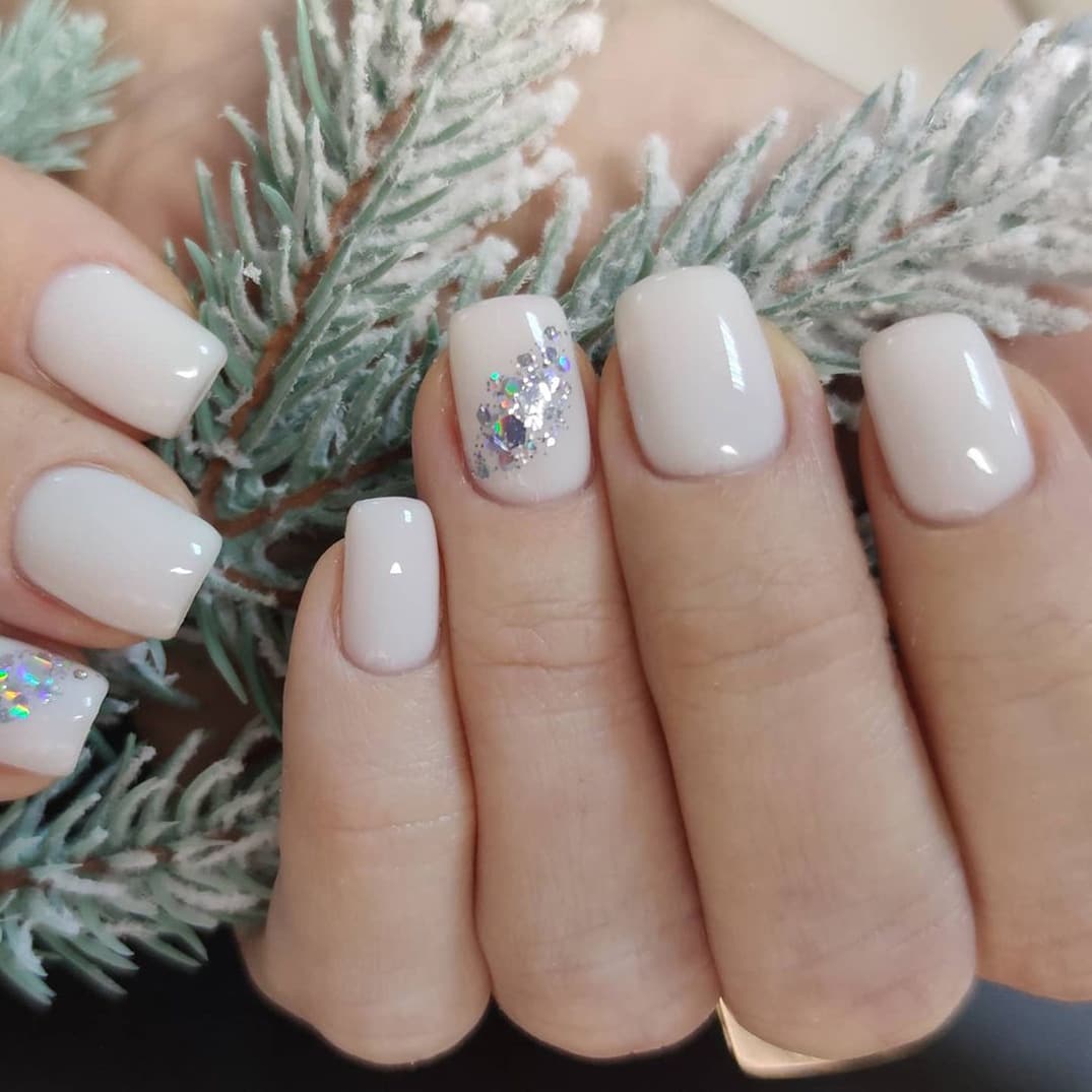 Short white New Year nails with silver sparkles