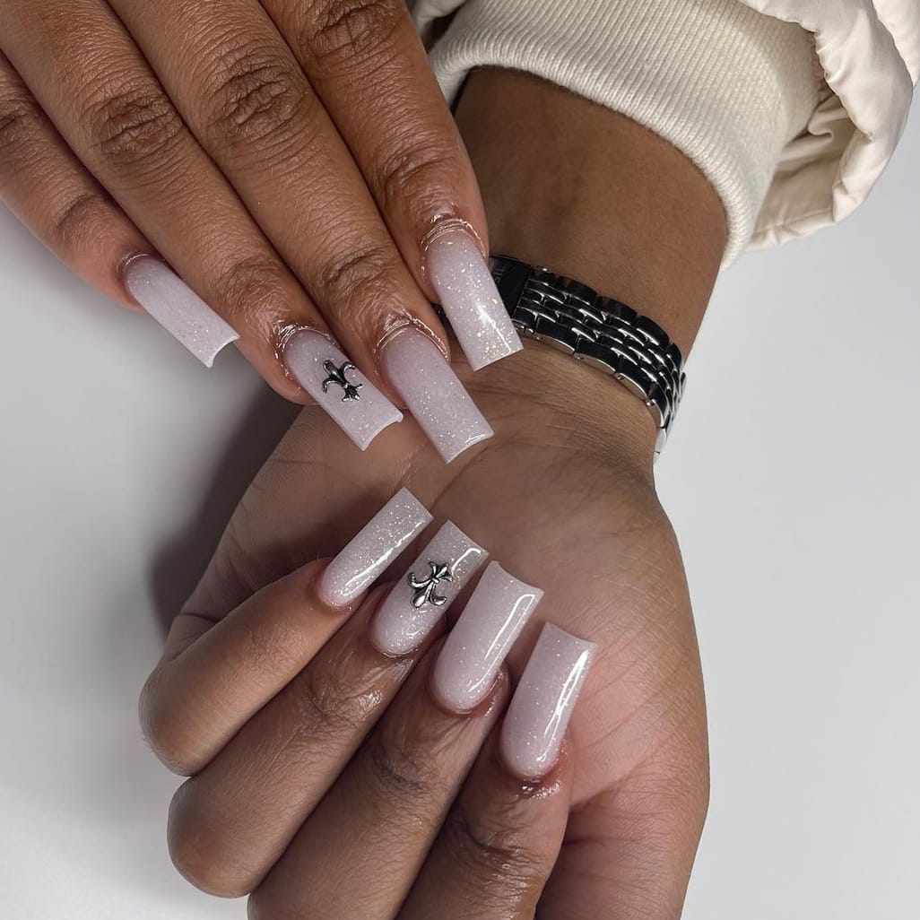 Glittering white birthday nails with minimalist symbols