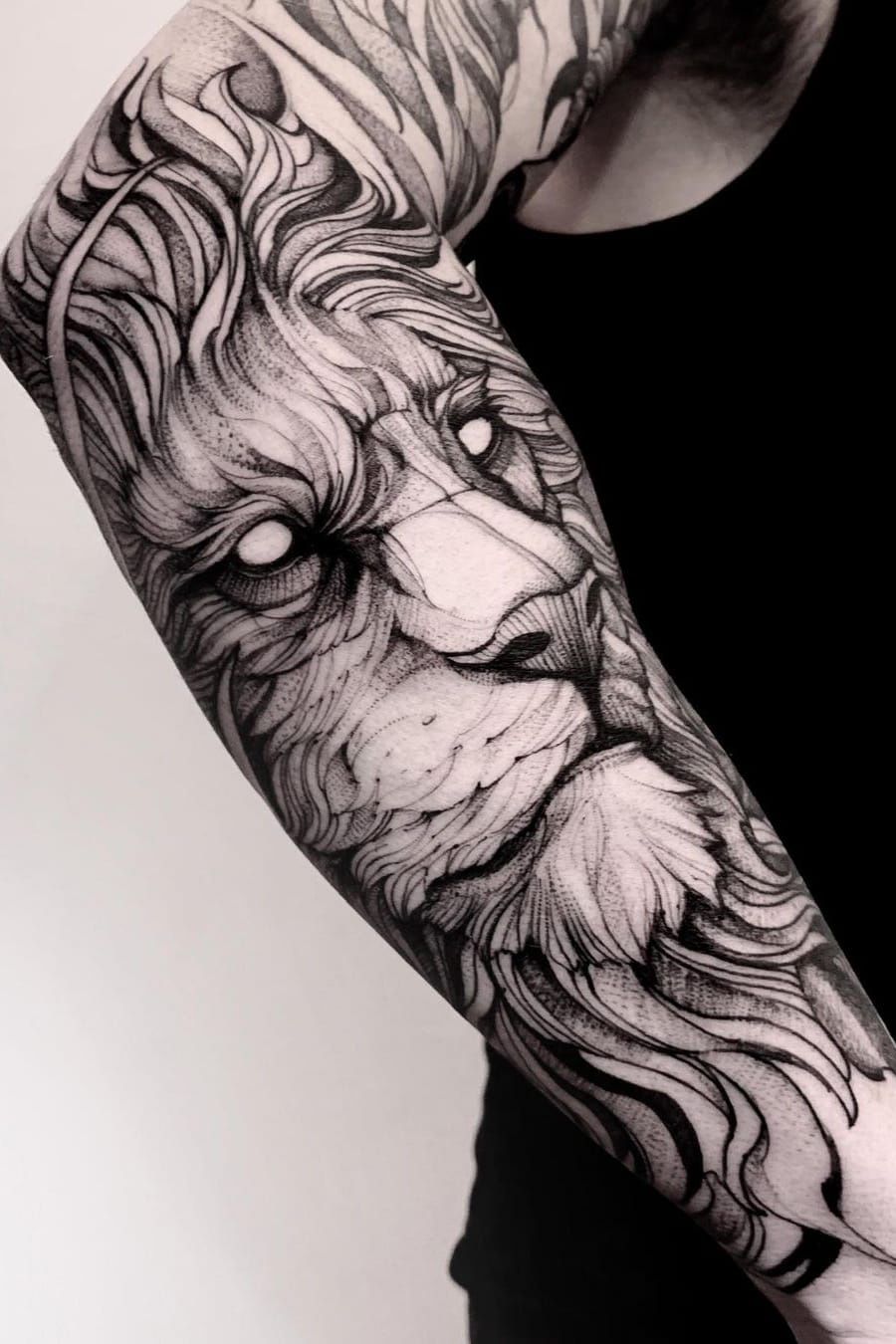 Black and white lion sleeve tattoo