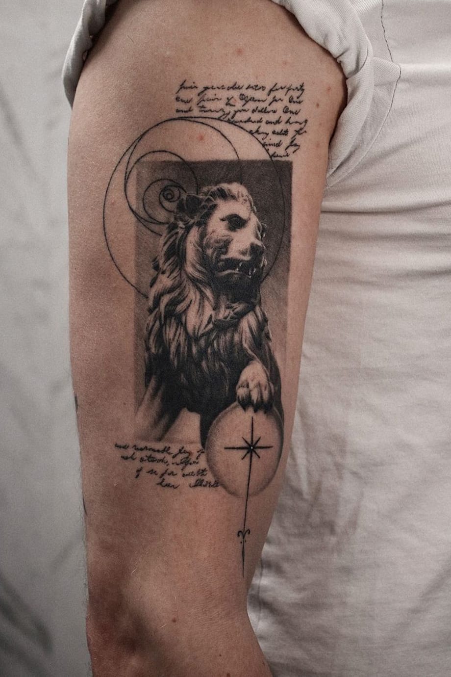 Lion statue tattoo