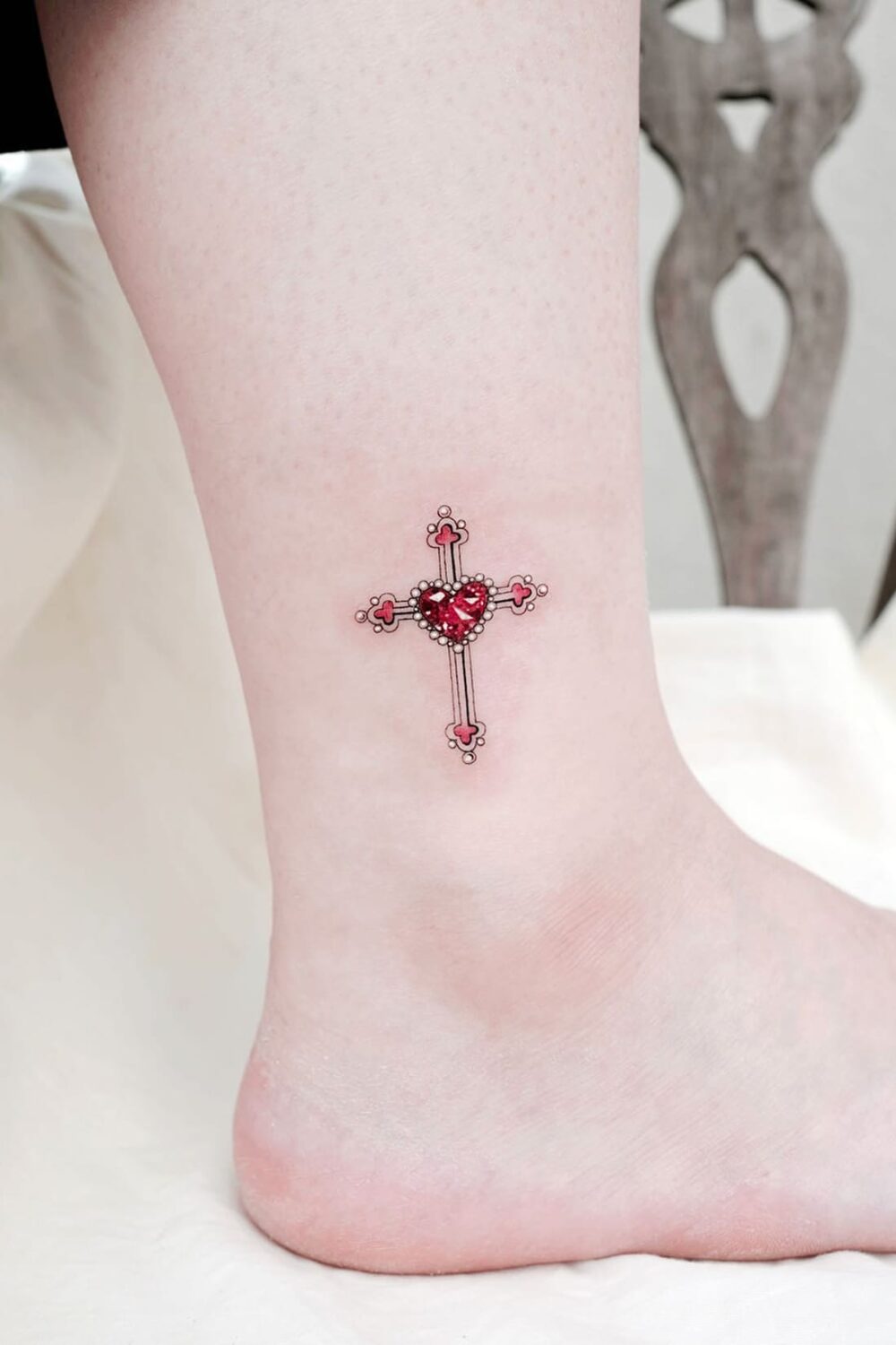 Small cross tattoo on ankle