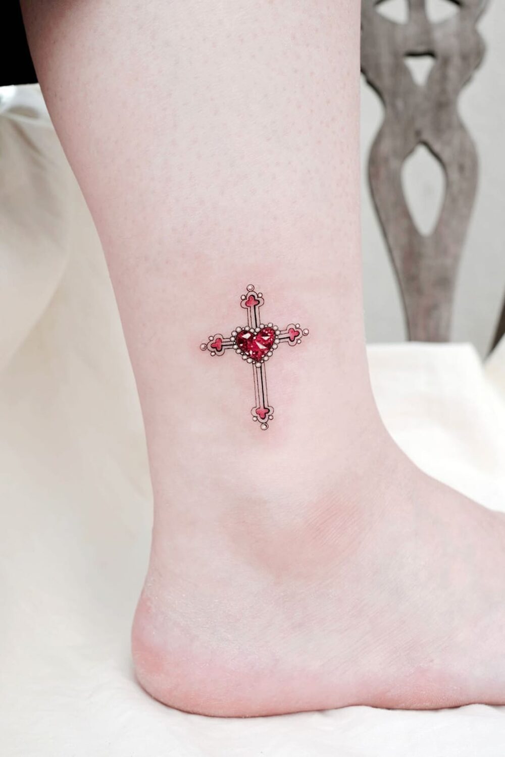 Small cross tattoo on ankle