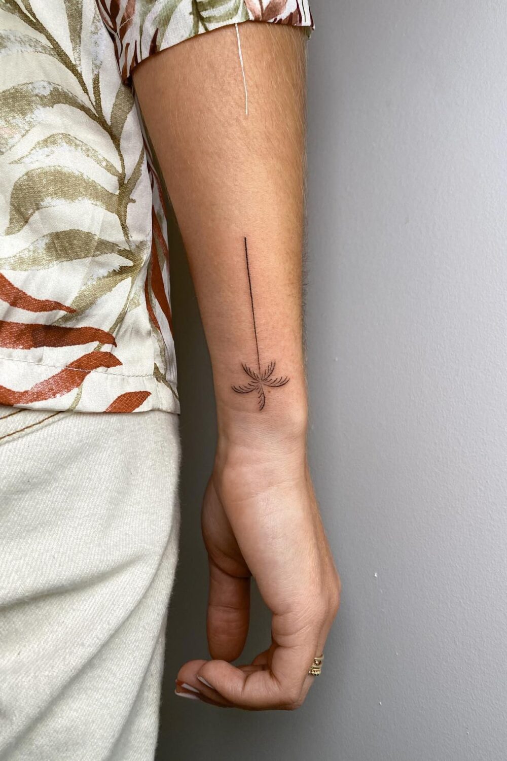 Minimalist palm tree tattoo