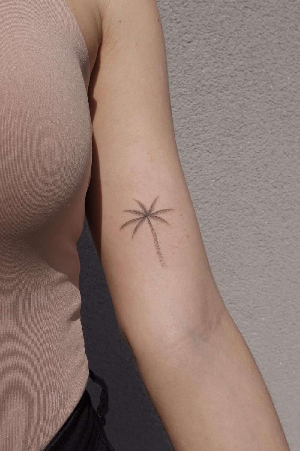 Minimalist palm tree tattoo