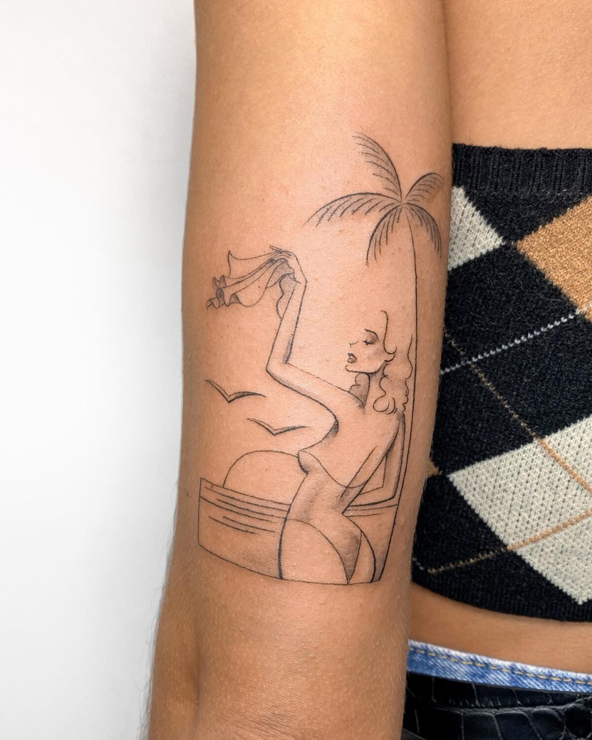 Palm tree tattoo with bird