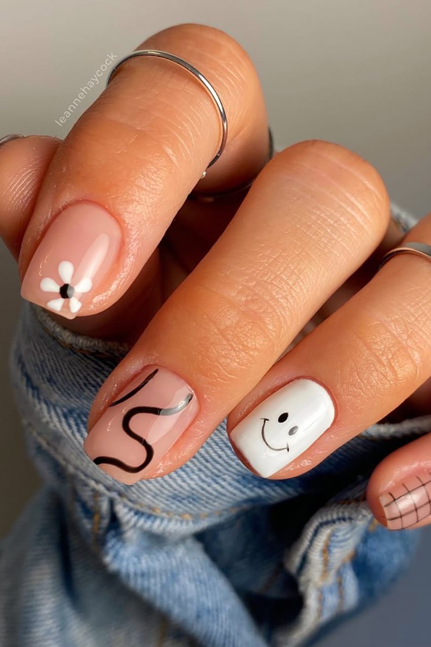 Black And White Nails With Smiley Face On Ring Finger
