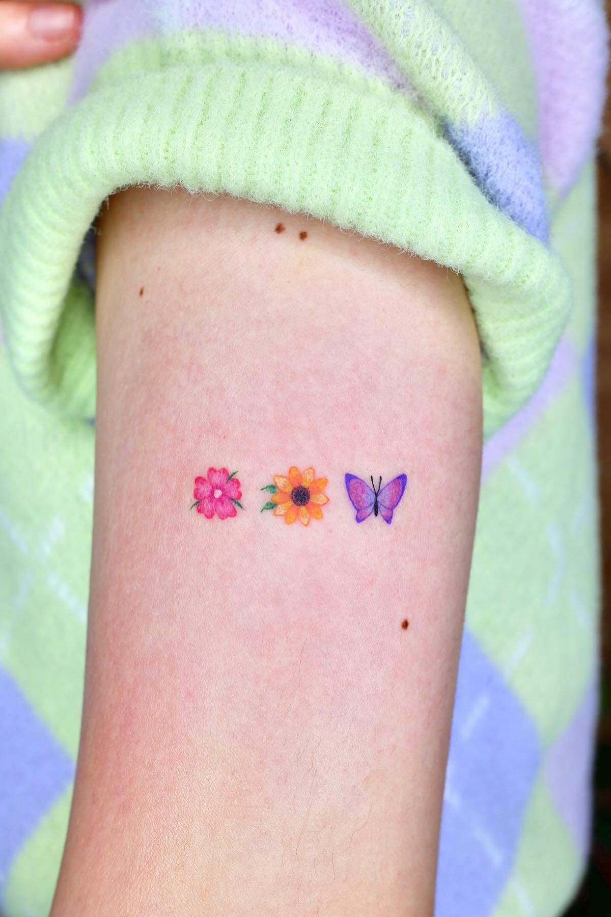 small butterfly and sunflower tattoo