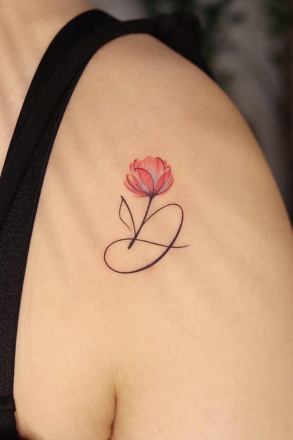 Small flower tattoo with letter
