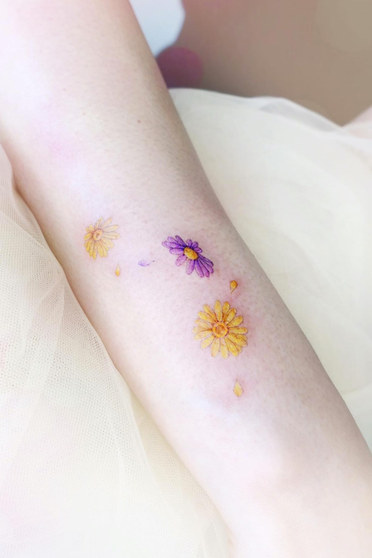 yellow daisy tattoo