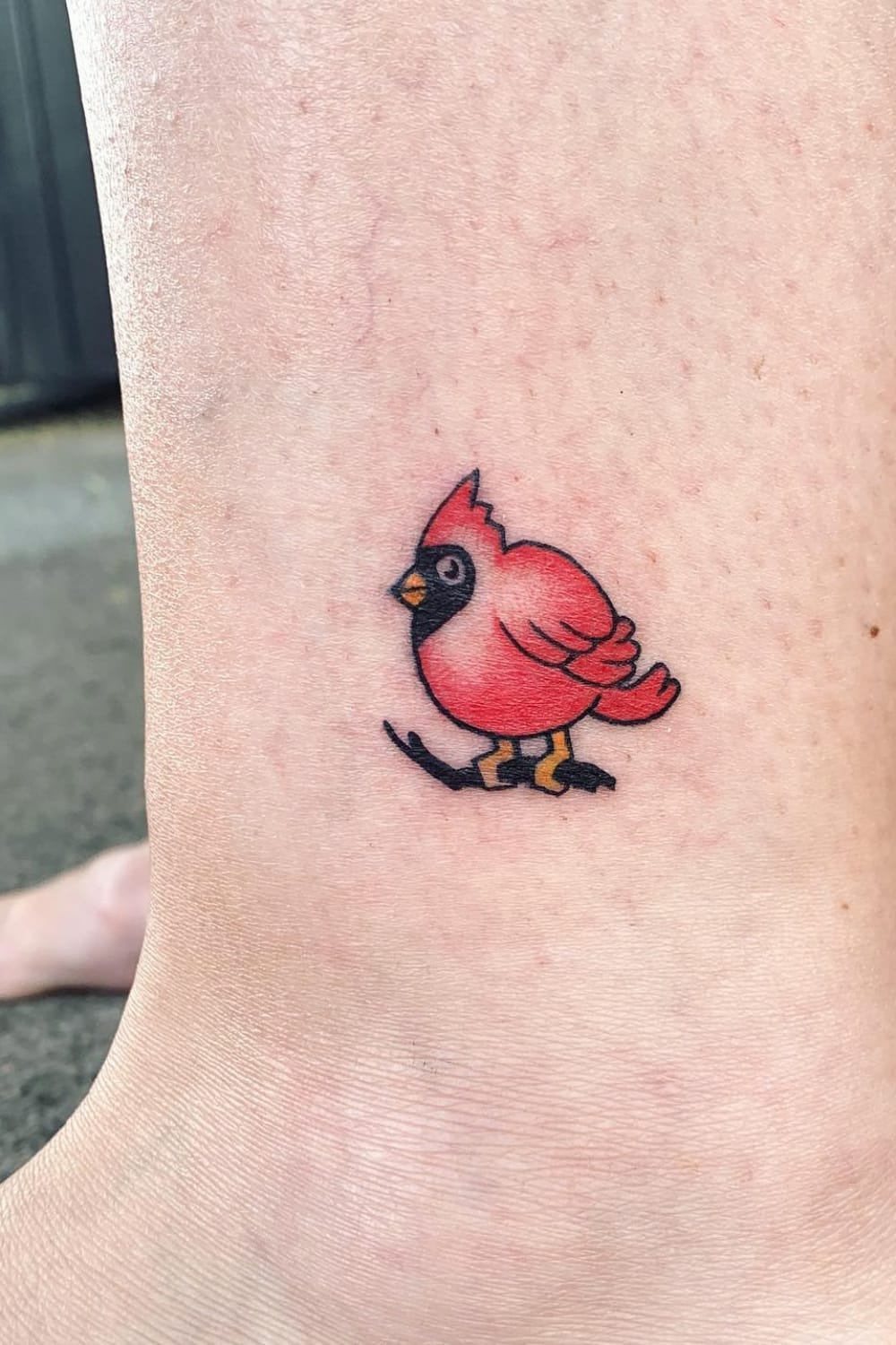 Cute small cardinal tattoo on ankle