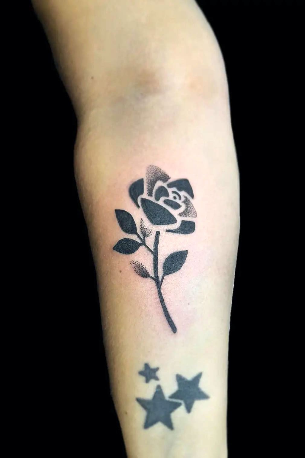 Small black geometric rose tattoo