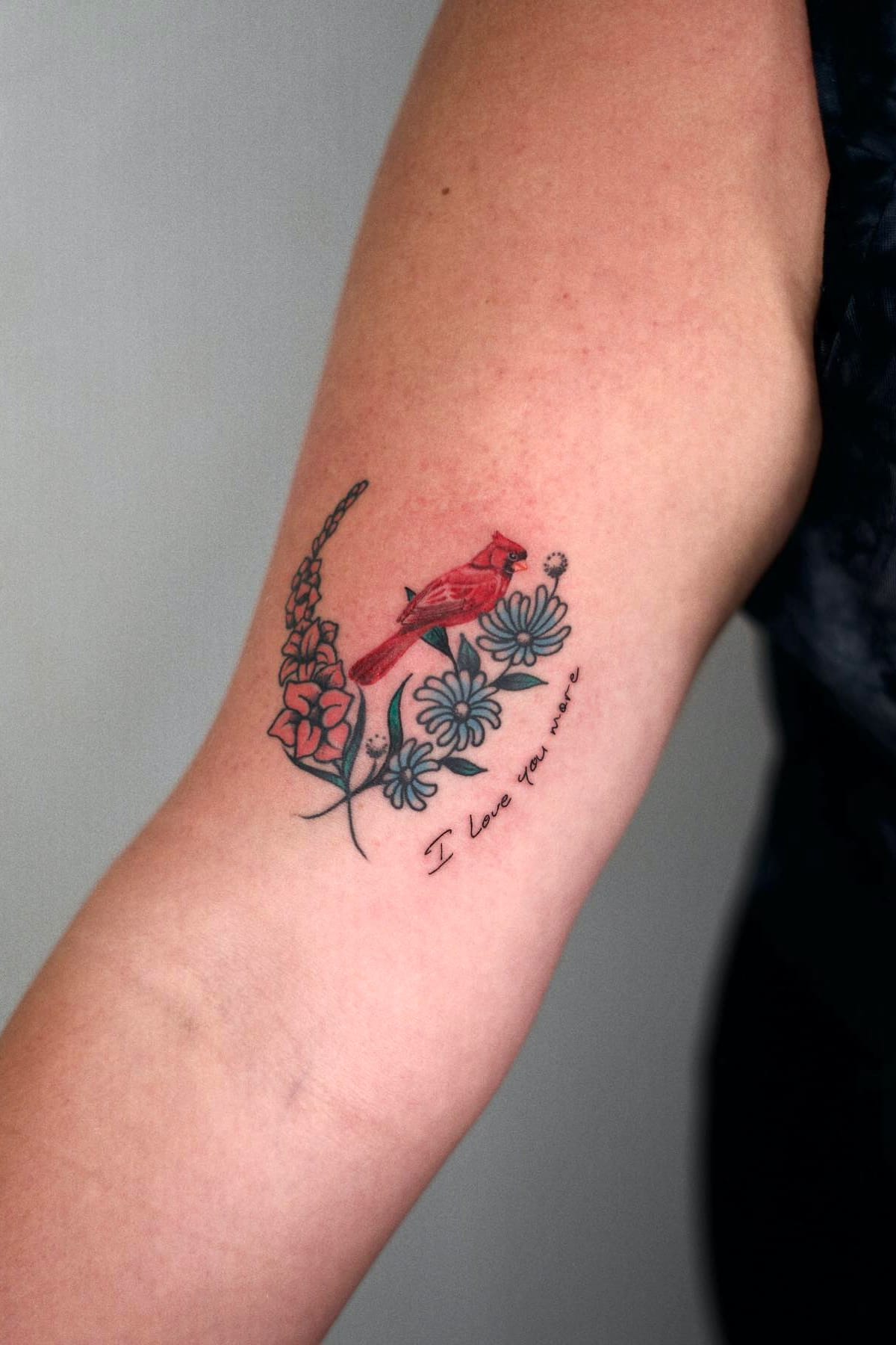 Small cardinal tattoo with flowers