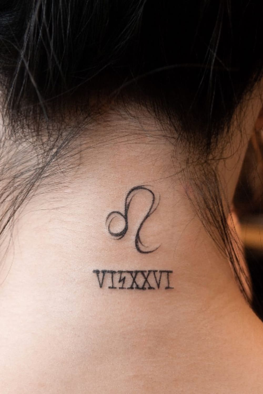 Leo Tattoo on Back of Neck