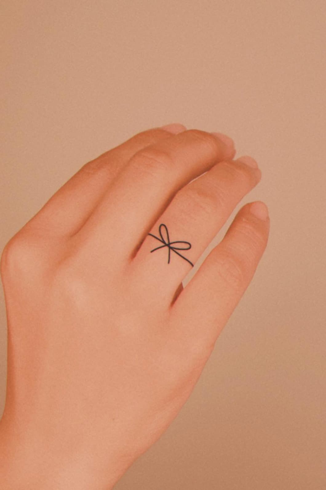 Minimalist Small Ribbon Tattoo