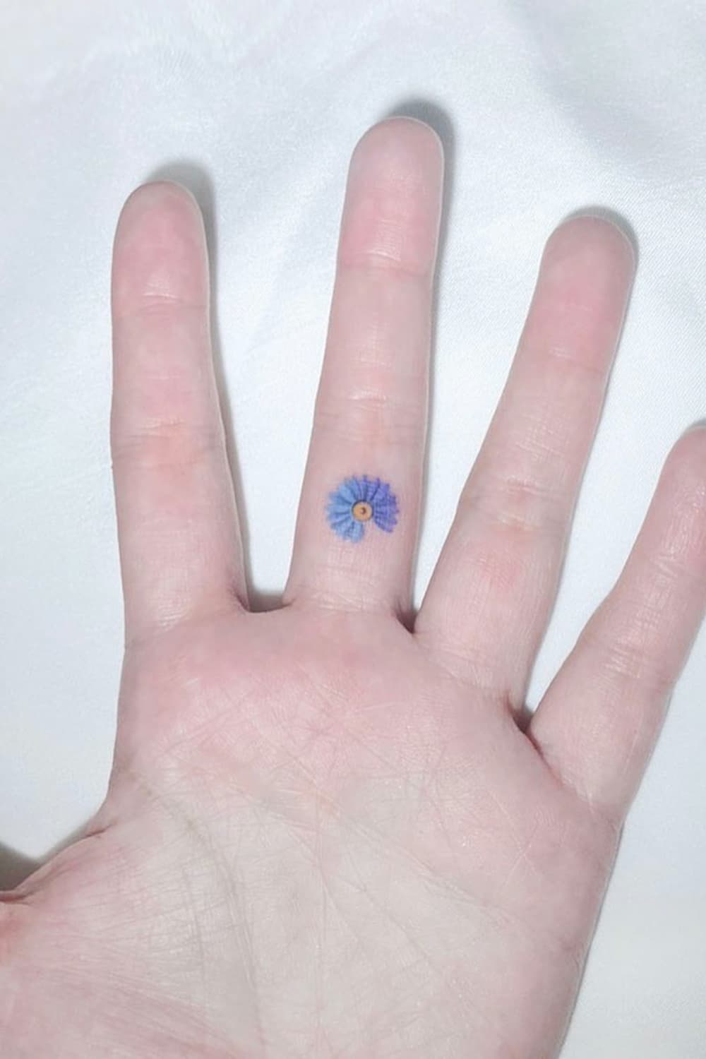 Cute Small Blue Daisy Tattoo
