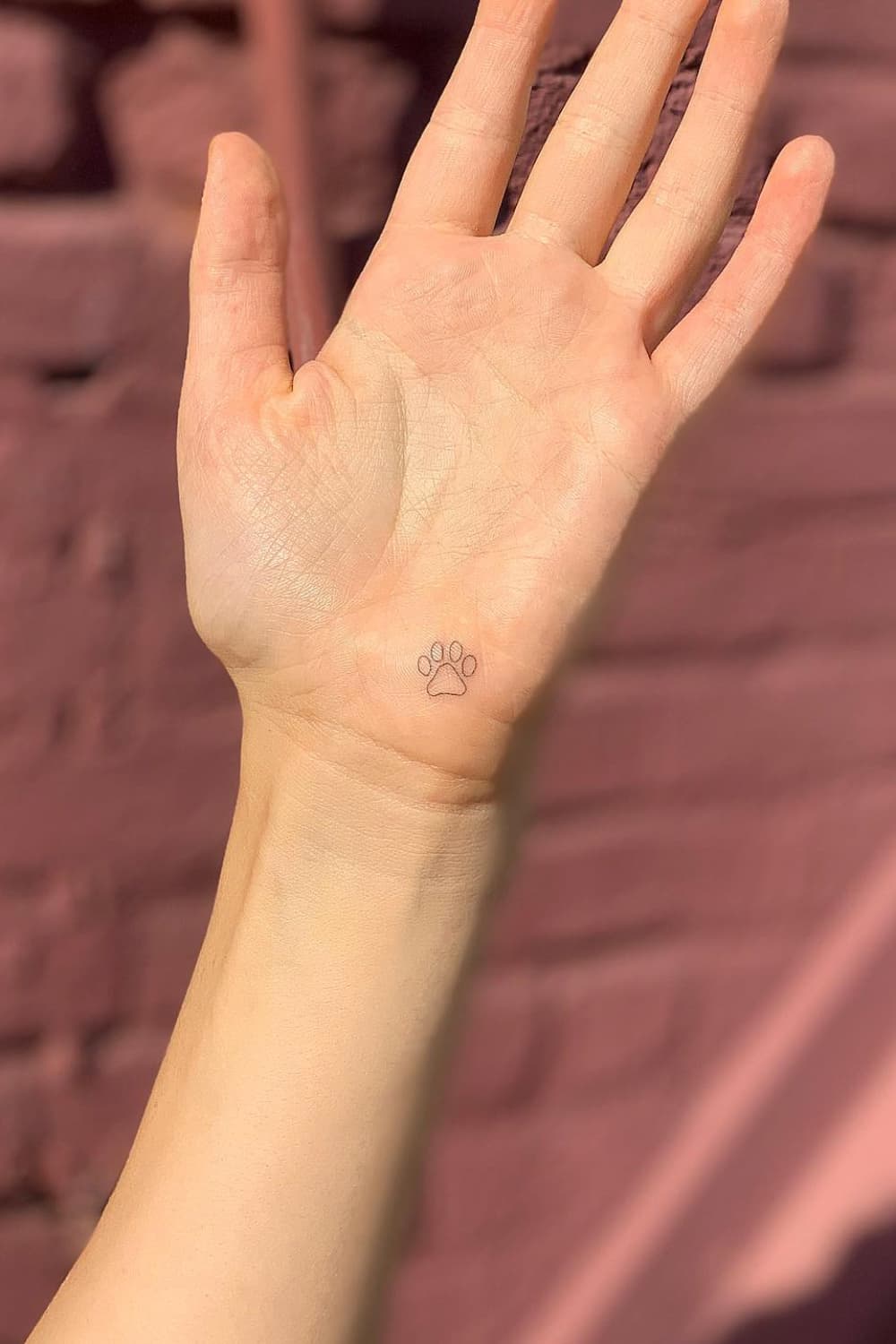 Small Paw Print Hand Tattoo
