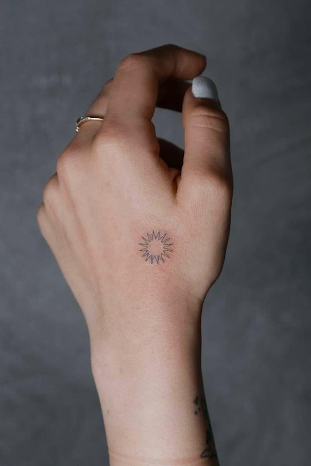 Small Sun Hand Tattoo
