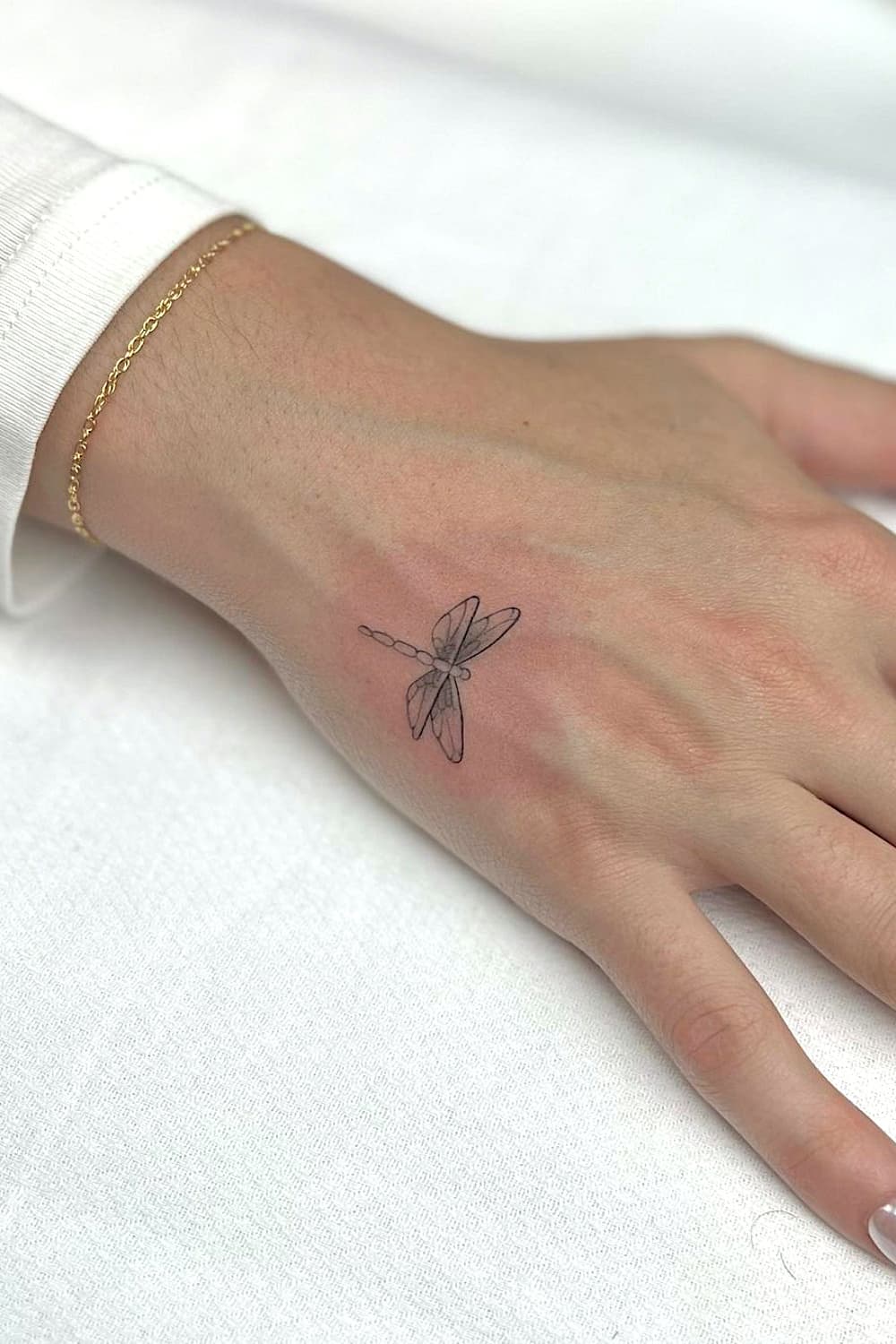 Small Dragonfly Hand Tattoo