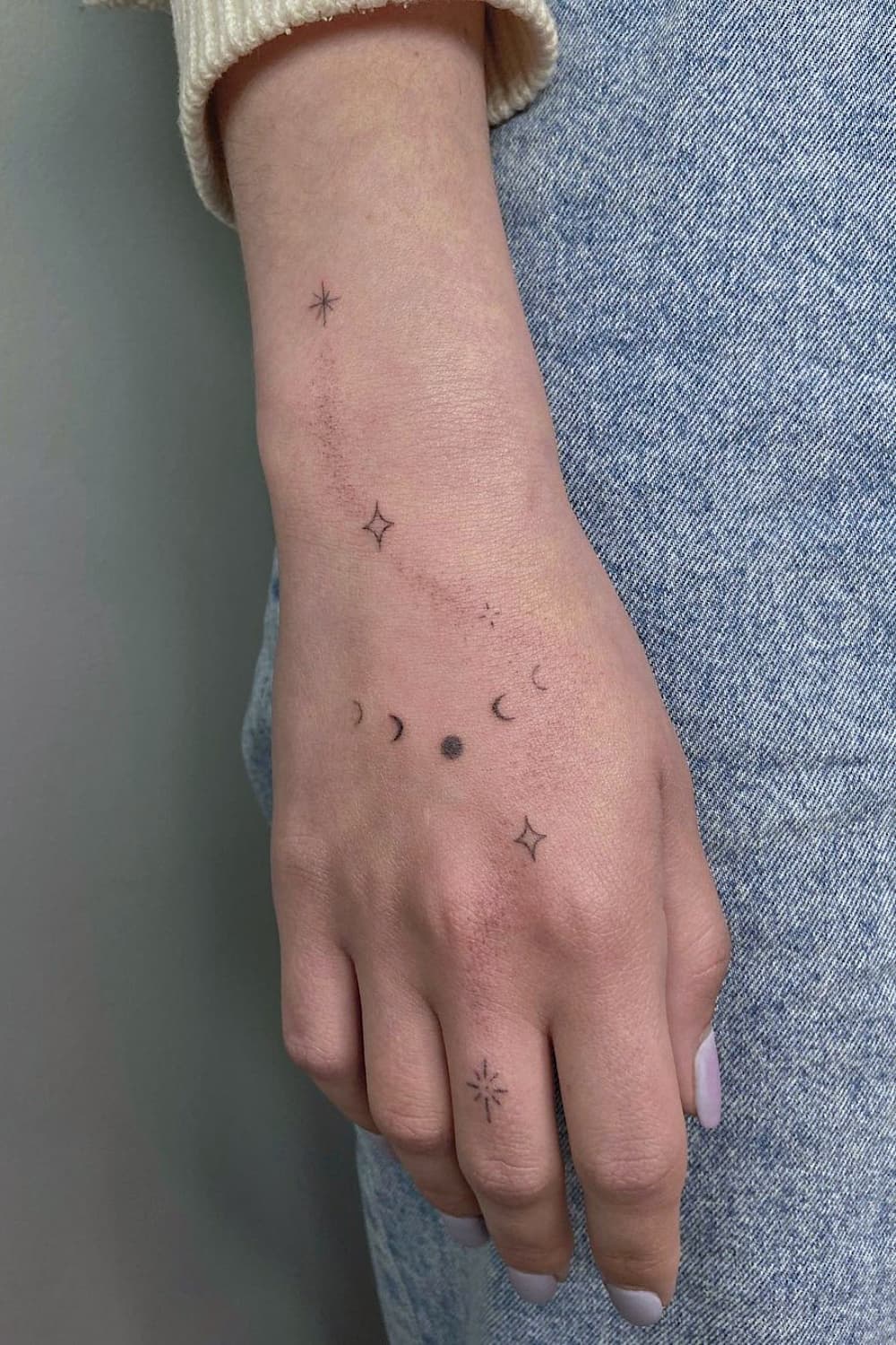 Small Moon Phase Hand Tattoo