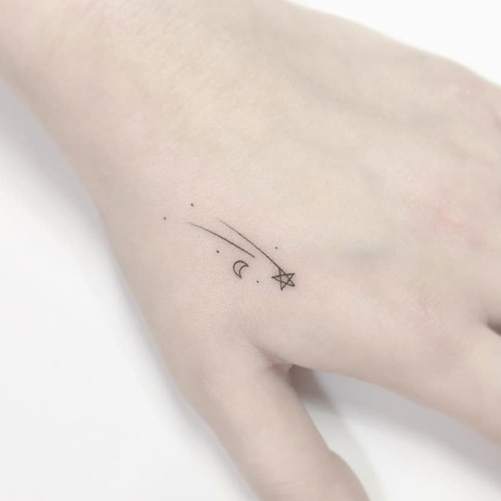 Small Meteor and Moon Hand Tattoo