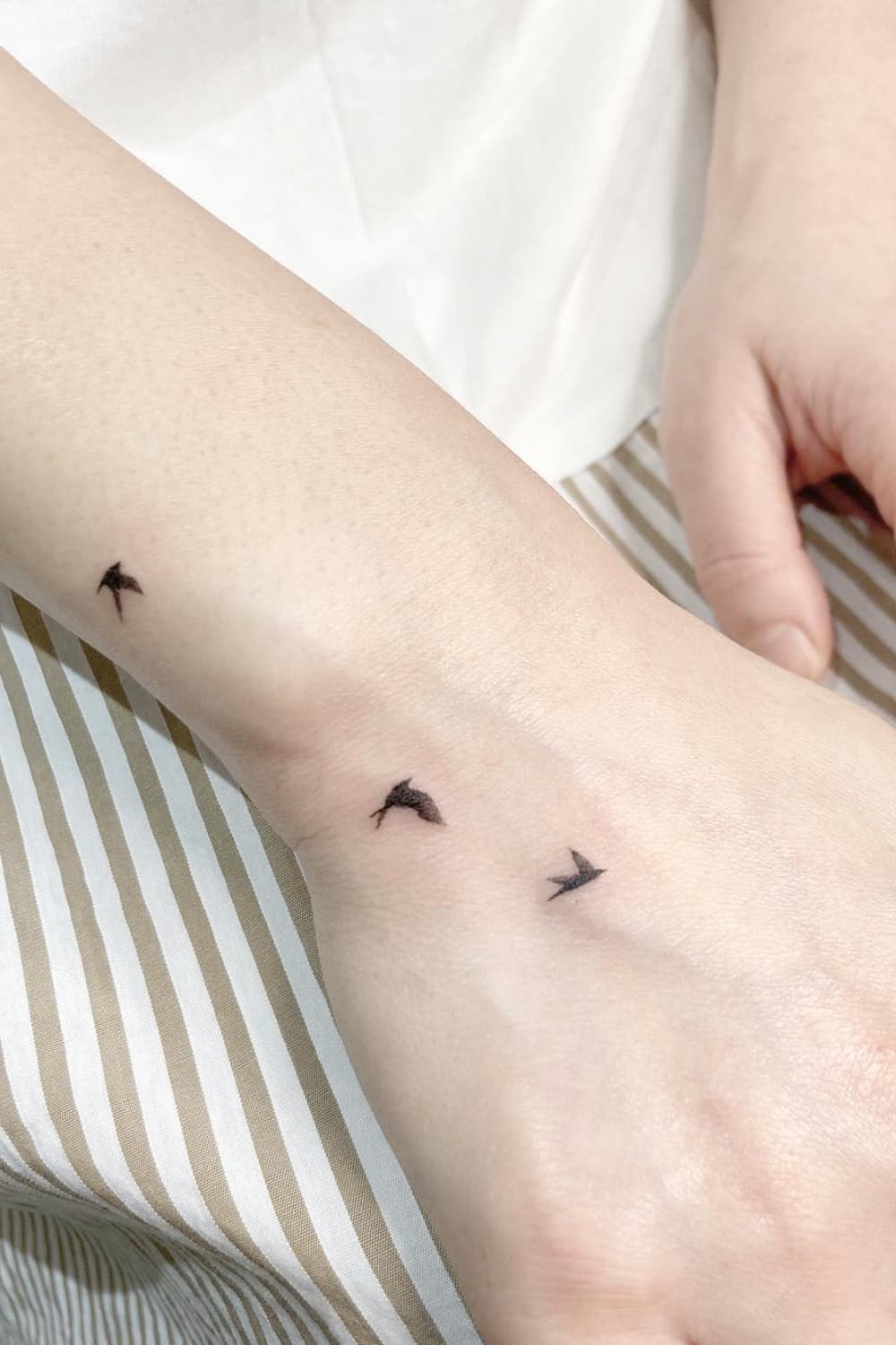 Small Bird Hand Tattoo